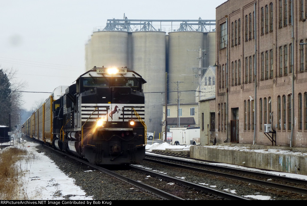Auto Racks hustle past the old Fleetwood auto body plant (right)